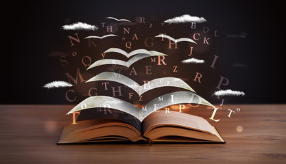 Wall Mural - Pages and glowing letters flying out of a book