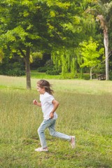 Side view of a young girl running at park