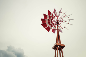 Red wooden Wind turbines with in the sunset