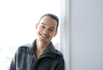 Wall Mural - Young asian man smiling at home