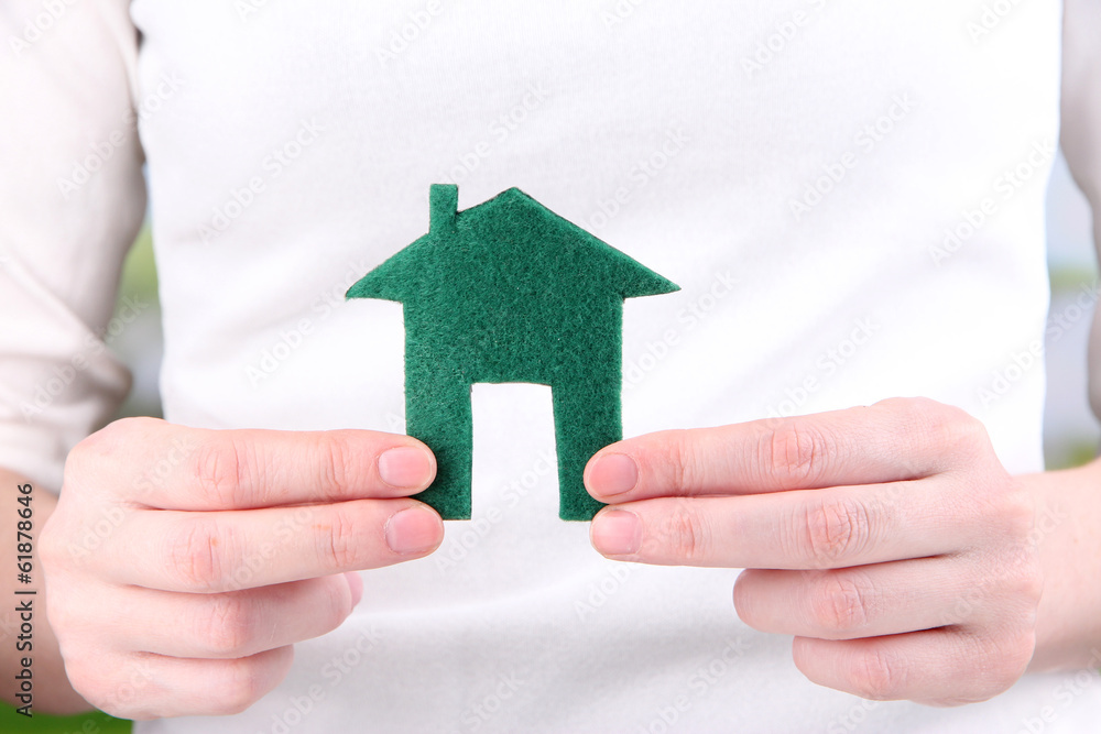Little paper house in hand close-up