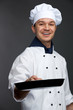 © Sergey - chef holding pan