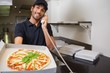 © WavebreakmediaMicro - Smiling pizza delivery man taking an order over the phone