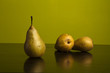 Still life of pears on green background