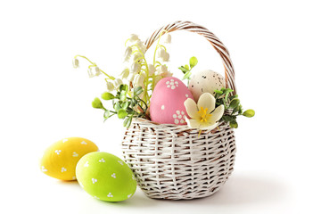 Wall Mural - easter eggs in basket isolated on white background