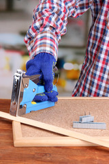 Poster - Fastening wooden lath and cork board using construction stapler