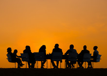 Group Of Business People Meeting At Sunset