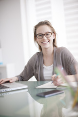 Wall Mural - beautiful young woman working on her laptop in her office