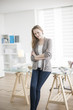 © jackfrog - beautiful young woman arms crossed standing in front of his desk