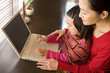 © TAGSTOCK2 - mother and girl looking at laptop