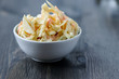Coleslaw in a bowl on a wooden table