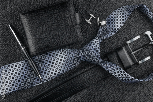 Fotografia Tie, belt, wallet, cufflinks, pen lying on the skin