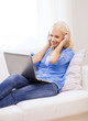 © Syda Productions - woman with laptop computer and headphones at home