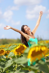 Summer girl happy in sunflower flower field