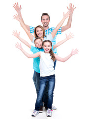 Wall Mural - Young happy family with children raised hands up