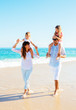 © EpicStockMedia - Happy Family on the Beach