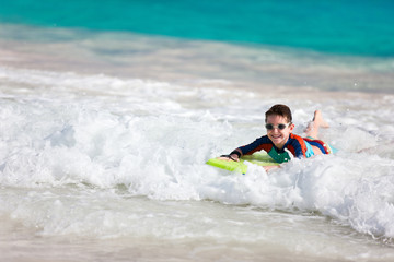 Wall Mural - Boy swimming on boogie board