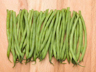 Fine green beans on a wooden background