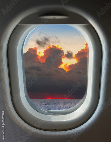 Fototapeta dla dzieci porthole, top view on the blue sky and clouds