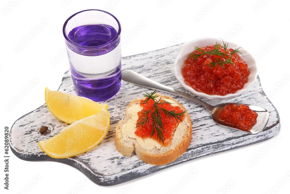 Sandwich with caviar and vodka on wooden board isolated on