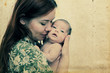 © dubova - young mother with her baby. Photo in old image style