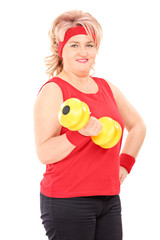 Sticker - Mature woman in sportswear lifting a dumbbell