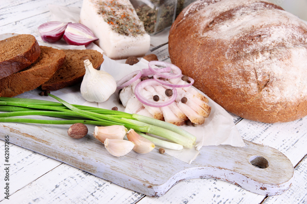 Rye bread with lard and onion on table close up