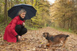 © DNF-Style - Woman with umbrella playing with her dog