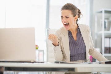 Wall Mural - Happy business woman in office rejoicing success