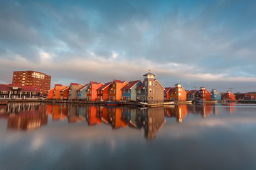 Fototapete - colorful buildings on water in morning sunlight