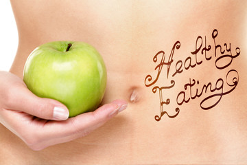 Healthy eating concept - woman stomach and apple