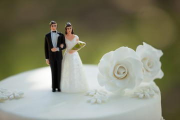 close-up of figurine couple on wedding cake