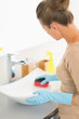 © Alliance - Closeup on housewife cleaning sink with sponge