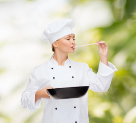 Poster - smiling female chef with pan and spoon