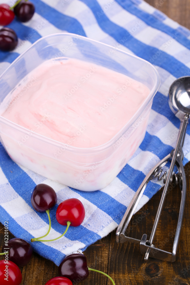 Ice cream in container and ice cream spoon