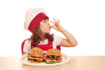 Wall Mural - little girl cook with ok hand sign and sandwiches