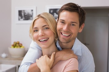 Wall Mural - Happy loving young couple in the kitchen