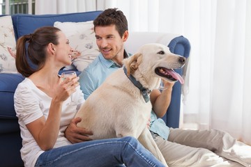 Wall Mural - Couple with wine glass and pet dog in living room
