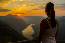 Girl Watching Sunset From The Top Of The Mountain