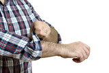 Fototapeta  - Man rolls up sleeves