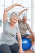 © WavebreakMediaMicro - Senior couple doing stretching exercises on fitness balls
