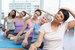 © WavebreakMediaMicro - Class stretching neck in row at yoga class