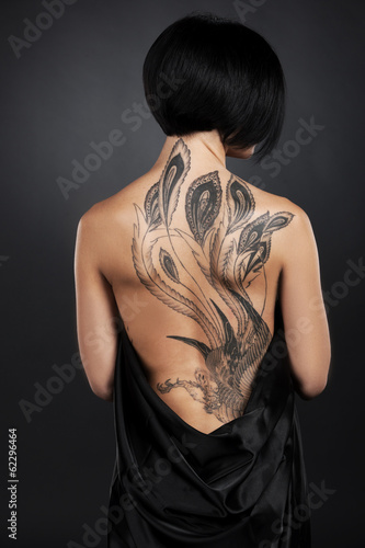 Naklejka dekoracyjna beautiful young lady with back tattoo.