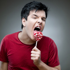 Canvas Print - casual man holding lollipop