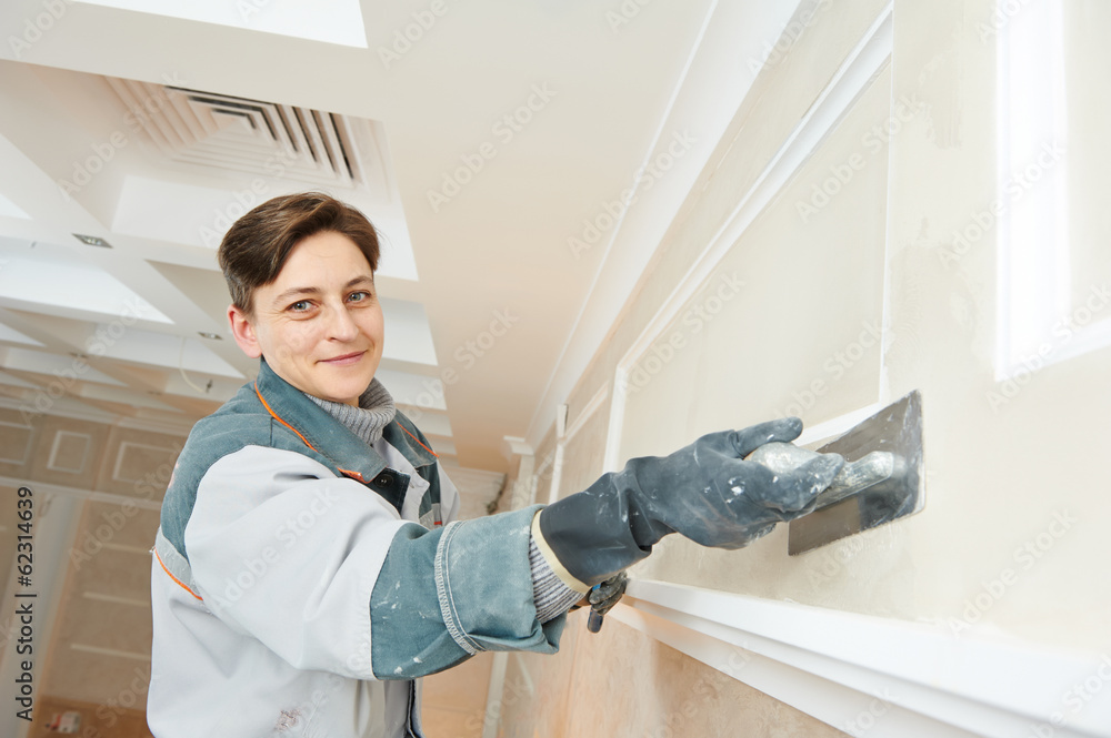 Plasterer at indoor wall work