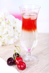 Poster - Glass of cocktail on table on light background