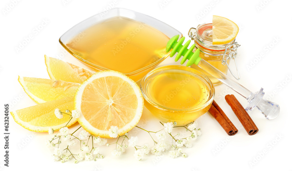 Sweet honey with lemon isolated on white