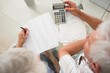 © Wavebreak Media - Senior couple using the calculator to pay bills