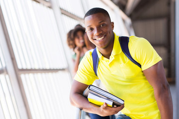 Wall Mural - male afro american student holding books