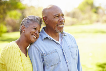 Senior Couple Walking Through Autumn Woodland